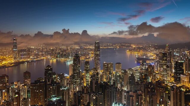 Asia, China,  Hong Kong, night to day transition zoom out time lapse of hong kong island financial district and Victoria bay, with high rise apartment blocks in foreground