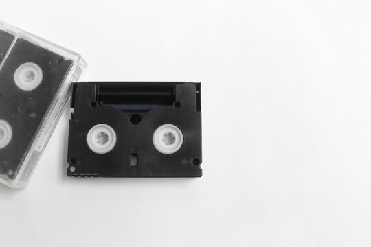 audio cassette tape, black and white two video cassettes isolated on white. retro technology concept with blank space for caption. 