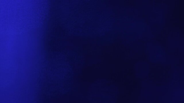 Patterned Glass Bokeh Drifting Counter to Sweeping Blue Light Beam - Deep Navy Motion Background⁠