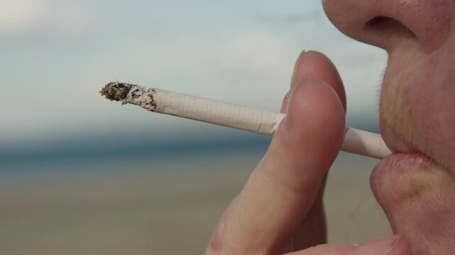 Woman smoker smokes cigarette, close-up, side view, harm to health, unhealthy lifestyle, bad habit