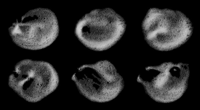 Abstract bubbles isolated on a black background. Top view of liquid white foam soap, shampoo, or shower gel. Clean concept for a suds product, realistic soap texture with detailed bubbles