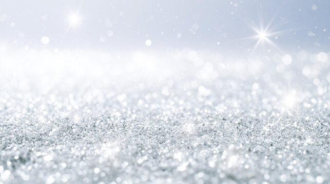 銀色のラメと雪のような光が広がる幻想的な冬の抽象背景
