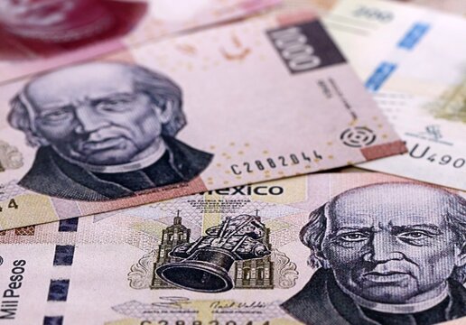 Mexican peso money bills pile on table. Mexico banknotes of MXN currency close up.