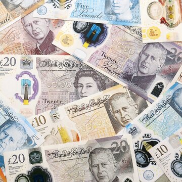 British pound money bills pile on table. United Kingdom banknotes of GBP currency close up.