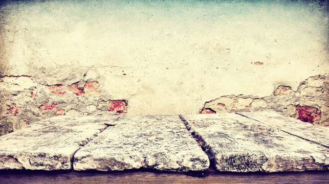 Rustic wooden table surface in front of a distressed concrete wall background.