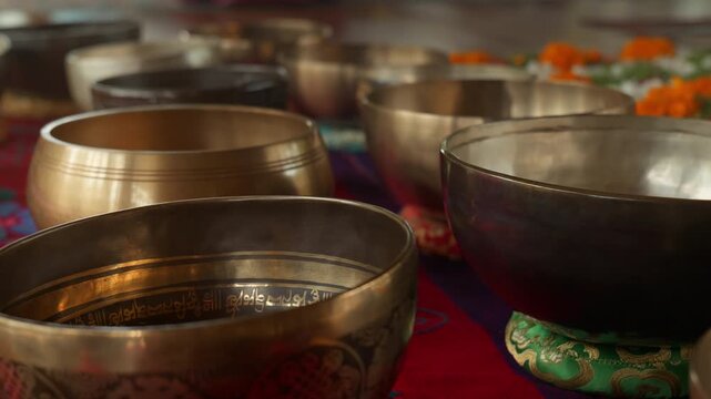 Tibetan singing bowls arranged, sound healing therapy, meditation instruments, vibrational wellness, acoustic therapy and spiritual healing.