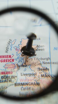 Exploring city destinations with a magnifying glass on a map of Belfast