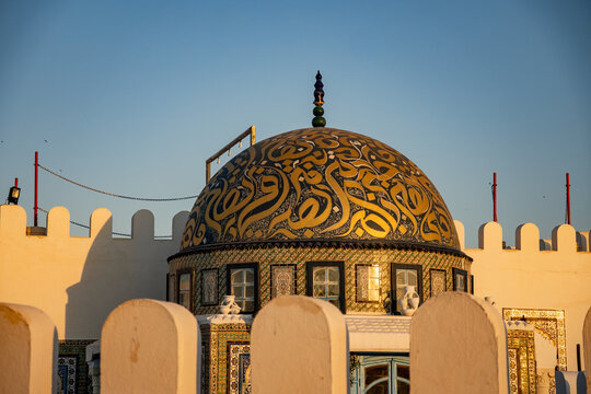Dome painted with stylized Arabic script in gold, in Kairouan, Tunisia