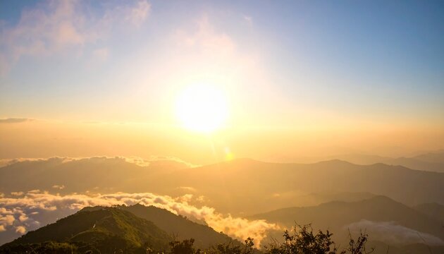 Golden sunrise over misty mountain peaks with sea of clouds