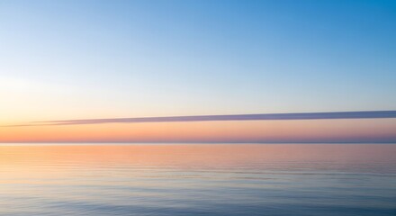 Fototapeta premium Calm ocean horizon at dawn with soft pastel sky and reflection on tranquil water surface
