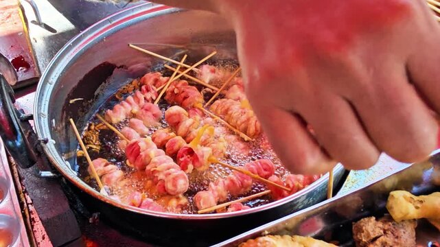 Traditional Indonesian fried snacks are displayed at a street food stall while a vendor fries them for customers. Authentic local cuisine featuring crispy homemade snacks and a vibrant street food cul