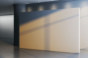 Obraz premium Big blank white wall board mockup standing in dark hall interior with gray column spotlights and tiled floor for exhibition poster placement. 3D Rendering