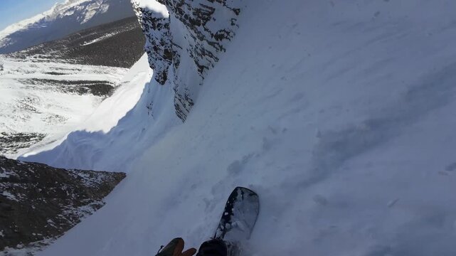 POV Snowboarding Steep Backcountry Couloir With Falling Snow In Canadian Rocky Mountains Slow Motion