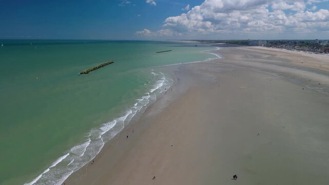 Aerial footage of beach and the city of Dunkirk, France. Dunkirk is a commune in the department of Nord in northern France.