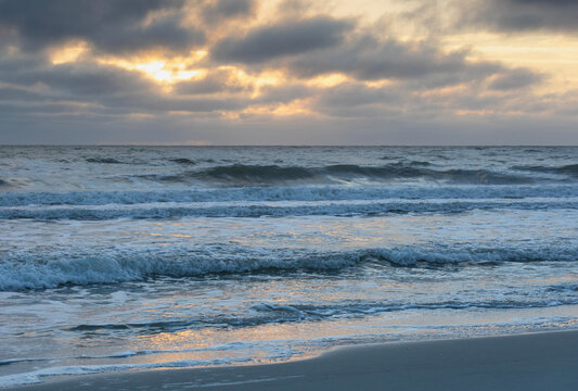 Pawleys Island tide going out with colorful sky behind