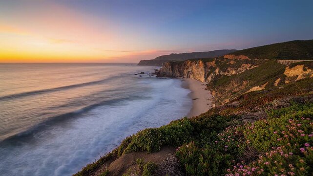 Cliffside ocean timelapse continuous waves rolling sky fades warm to cool dramatic scenery
