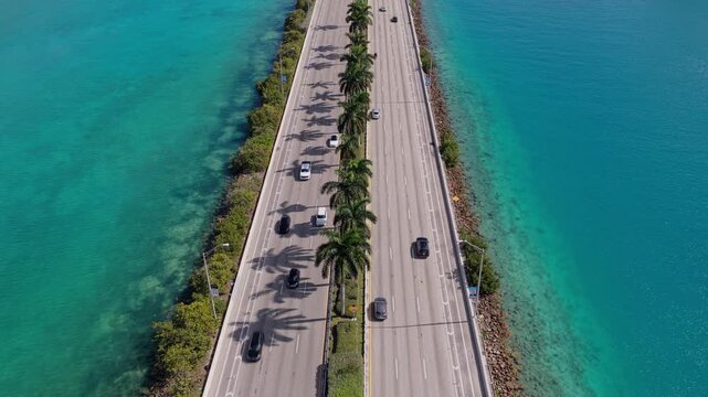 MIami, FLorida, USA - July 24, 2025: Urban roadway. MacArthur Causeway. Roadway Downtown Miami to Miami Beach. Car traffic road highway. Urban traffic. Road way many car. Cars on causeway road