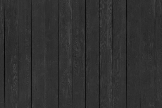 A black wooden wall with vertical planks. A dark timber surface texture.
