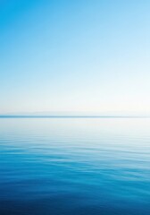 Obraz premium A vast expanse of calm blue ocean stretches toward the hazy horizon under a clear sky, capturing the serene and endless beauty of the deep, solitude, reflection, atmospheric