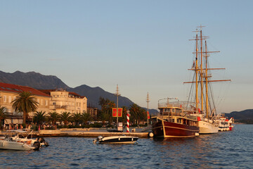 Traditional wooden ship and large sailing vessel moored at the promenade in Tivat, Montenegro. © Predrag