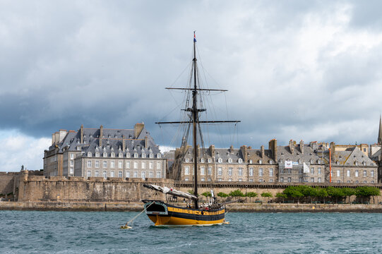 High tide in Brittany with view toward walled city of Saint-Malo. Coastal Atlantic landscape with boats and dramatic tidal range of Emerald Coast, France, boat travel