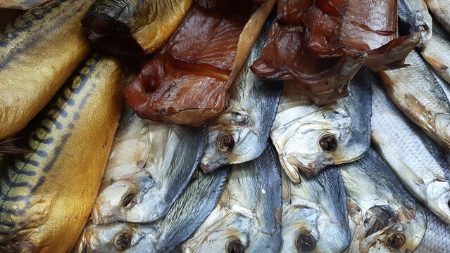 A selection of dried and smoked fish&mdash;a traditional beer snack. A close-up of freshly prepared fish delicacies, including Caspian roach, sabrefish, whitefish, and other varieties. Natural scale texture