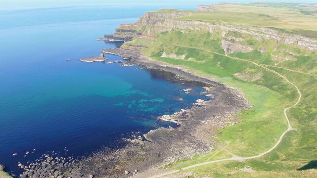 Spectacular aerial view of the iconic Giant's Causeway coastline in Northern Ireland. Drone Video of basalt columns, cliffs and Atlantic Ocean, and breathtaking coastal scenery