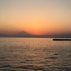 Fototapeta premium 夕闇に包まれる海と富士山のシルエットが描く静かな風景