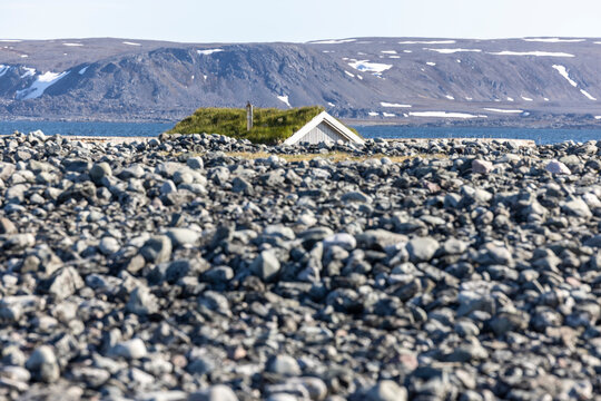 Wooden cabin with a grass roof on the coast of the Barents Sea on the Varanger Peninsula near Hamningberg, Finnmark county, Norway