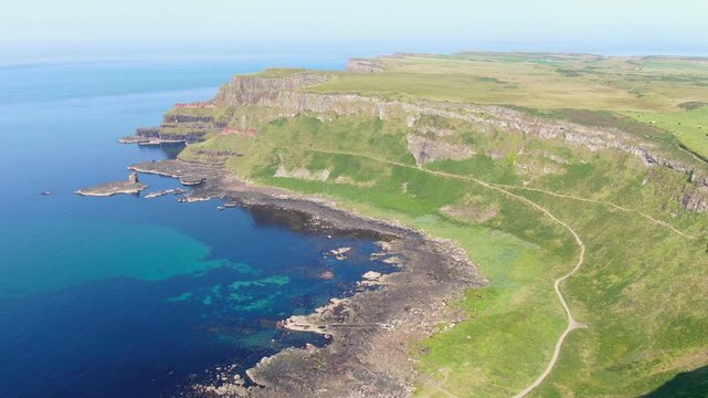 Spectacular aerial view of the iconic Giant's Causeway coastline in Northern Ireland. Drone Video of basalt columns, cliffs and Atlantic Ocean, and breathtaking coastal scenery