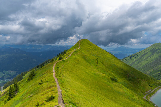 the summit called "Gehrenspitze" in the little valley of Walser, Austria on a cloudy summer day. hiker walking a tightrope up under changing weather. holiday destination for hiker and climber