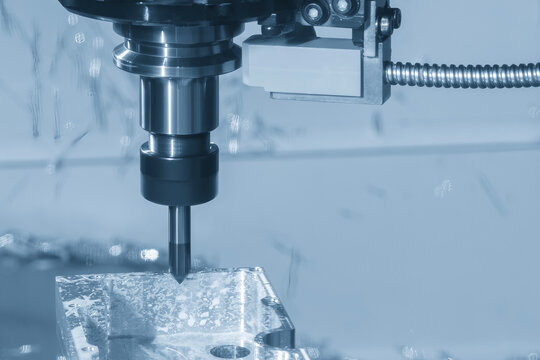 High-precision CNC milling machine performing a chamfering cut process on an aluminum case part.