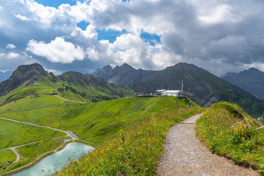 Ski lift valley station in little valley of Walser, mountain railway in spring on a blooming alpine meadow, many different alpine flowers form a colorful pasture for the cows