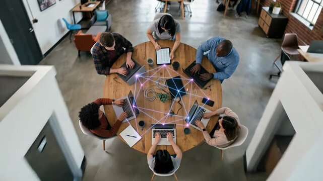 Diverse team collaborating on data network project at round table