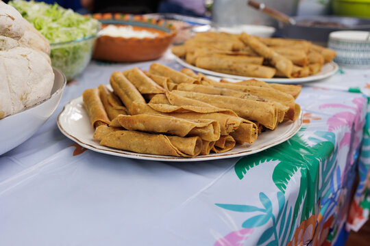 flautas de pollo or chicken fried tacos in Mexico Latin America, Mexican feast with Homemade food on table