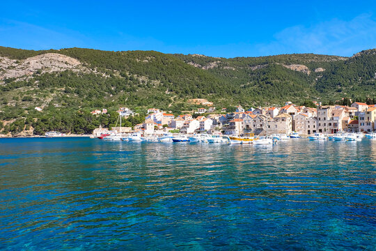 Boats, local houses and Adriatic sea at Vis island town