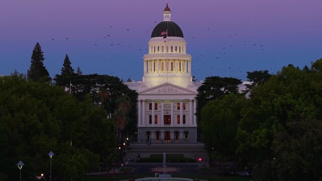 Aerial view shows the west side of California State Capitol building at night with new annex construction seen in the east