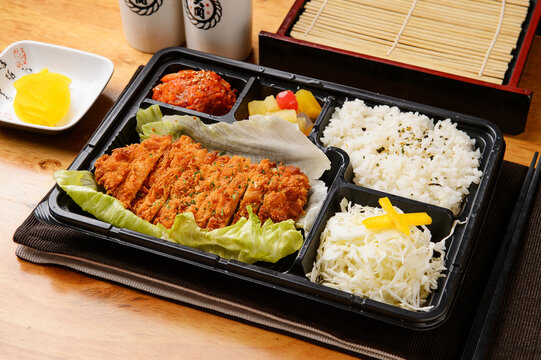 Korean lunch box dosirak with rice sausage and side dishes