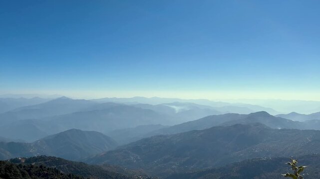 Panoramic landscape of layered mountain ridges fading. Atmospheric haze, vast clear sky above mount everest. Global travel tourism, majestic outdoor adventure. Nature wilderness summer, uttarakhand 