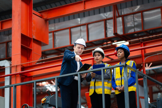 Industrial leadership and factory inspection. Engineers and managers review production operations on a manufacturing platform. Leadership, inspection, industry, teamwork, manufacturing
