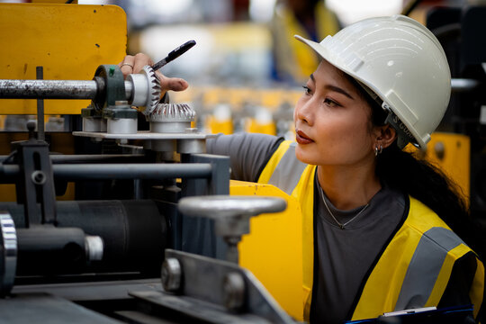 Happy women engineer worker enjoy working in factory industry.