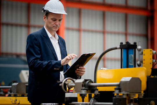Caucasian professional Engineer factory. Engineering worker in safety hardhat at factory industrial facilities. Heavy Industry Manufacturing Factory