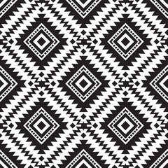 Fototapeta premium Intricate black and white Aztec tribal seamless pattern vector illustration. Modern flat southwestern ethnic geometric diamond navajo repeat background with zigzag chevron motifs.