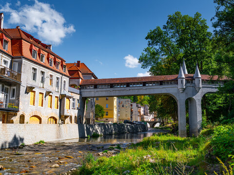 2025-09-01; Historic covered bridge with towers over a river in Ladek Zdroj Poland.