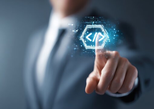Businessman touching a glowing code bracket icon on a digital interface representing software development and programming technology with programming software developer technology