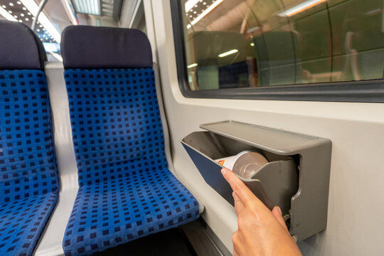 Small trash bin mounted between seats inside German S-Bahn train carriage