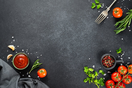 Black empty plate, Fresh herbs, spices and vegetables.