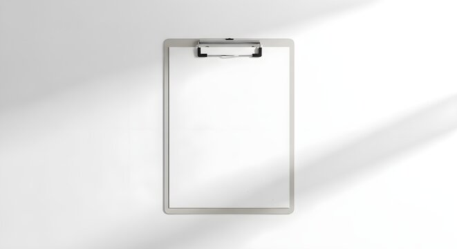 Minimalist clipboard with blank white paper on a clean background, top view mockup for document display or presentation, simple and professional design with subtle shadows