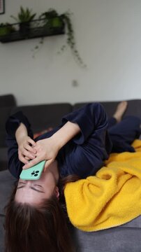 Vertical screen Endless social media scrolling promises instant pleasure yet leaves a young woman feeling emotionally drained as she chases quick dopamine after waking