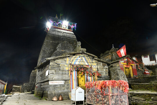 Illuminated stone facade of Tungnath Temple at night	